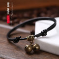 Adjustable black nylon rope dog collar for small dogs featuring a brass bell, shown alongside red and coffee colour options.