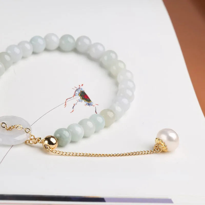Jade green pearl bracelet with geometric pendant and peace buckle clasp on wrist