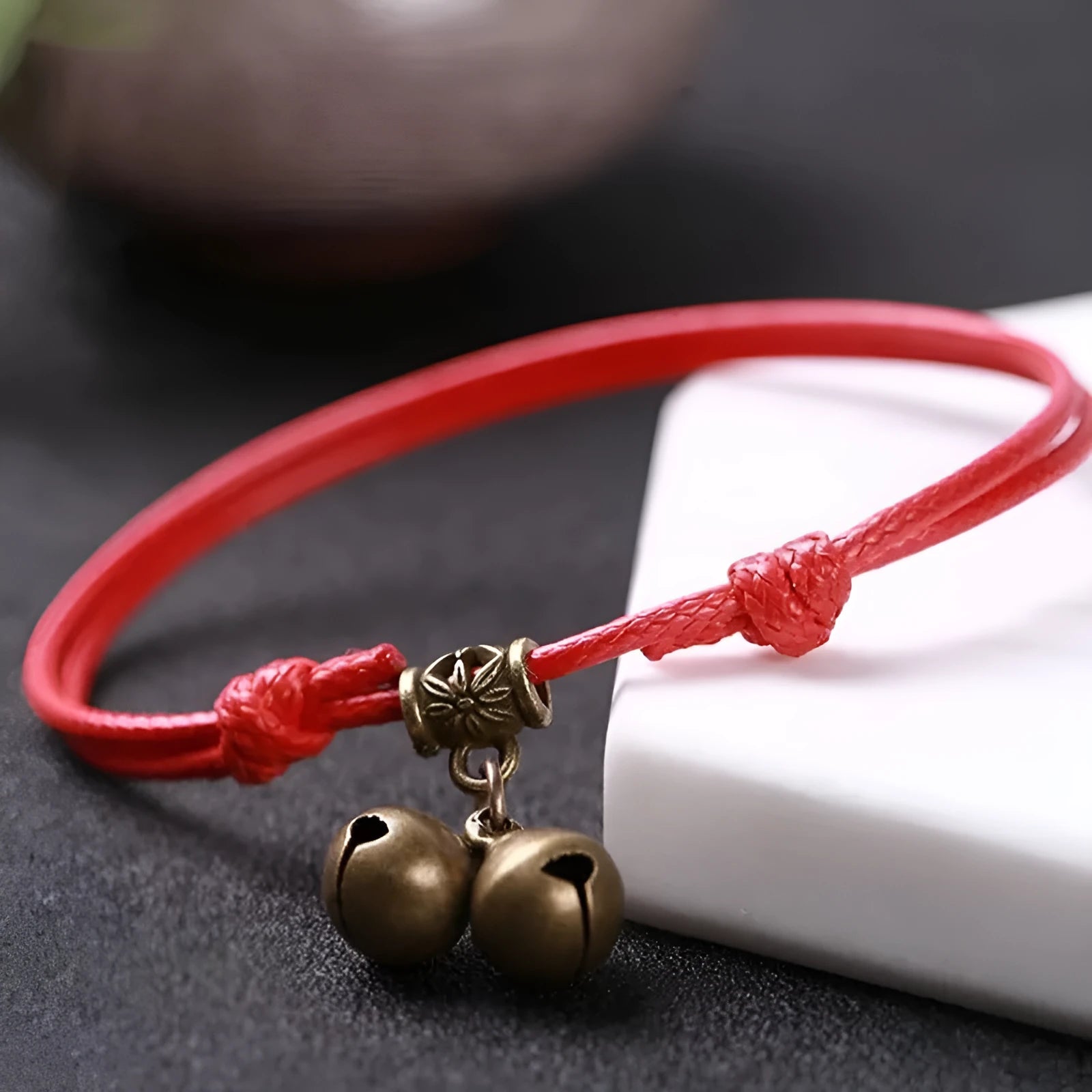 Adjustable black nylon rope dog collar for small dogs featuring a brass bell, shown alongside red and coffee colour options.