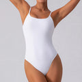 Woman wearing slim grey sleeveless yoga jumpsuit in triangle design
