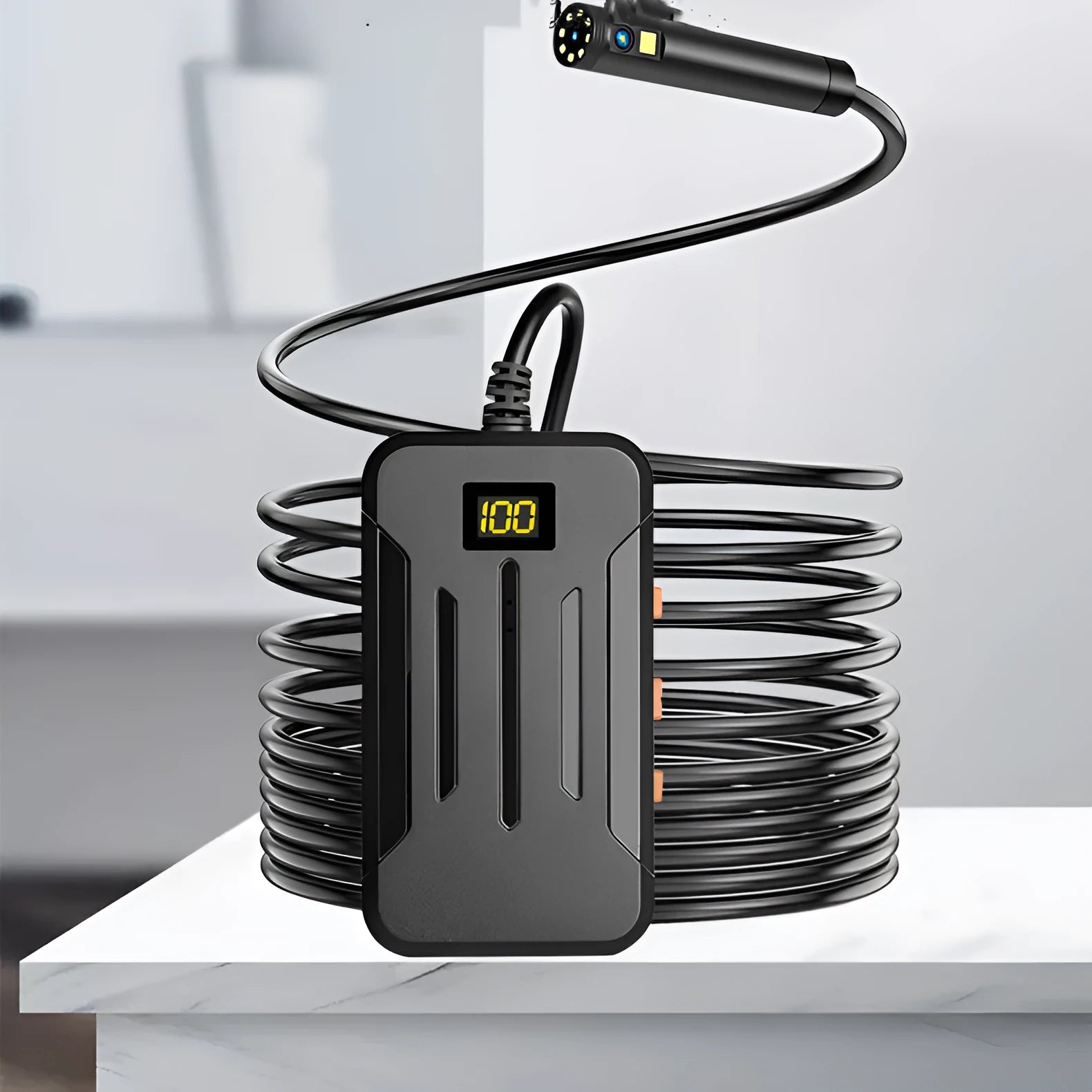 F300 wireless dual lens endoscope camera with 5.5mm and 8mm probes, hook, and magnet attachments on a table.