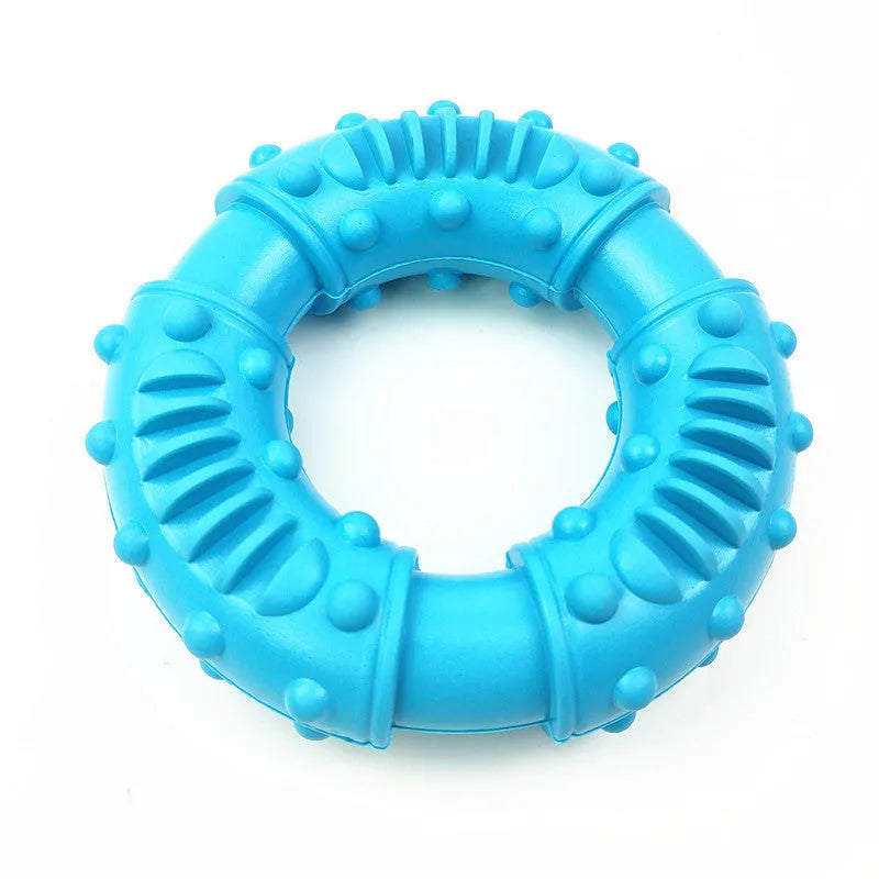 Blue hollow dog fetching stick toy on grass, showing its chewable texture and size.
