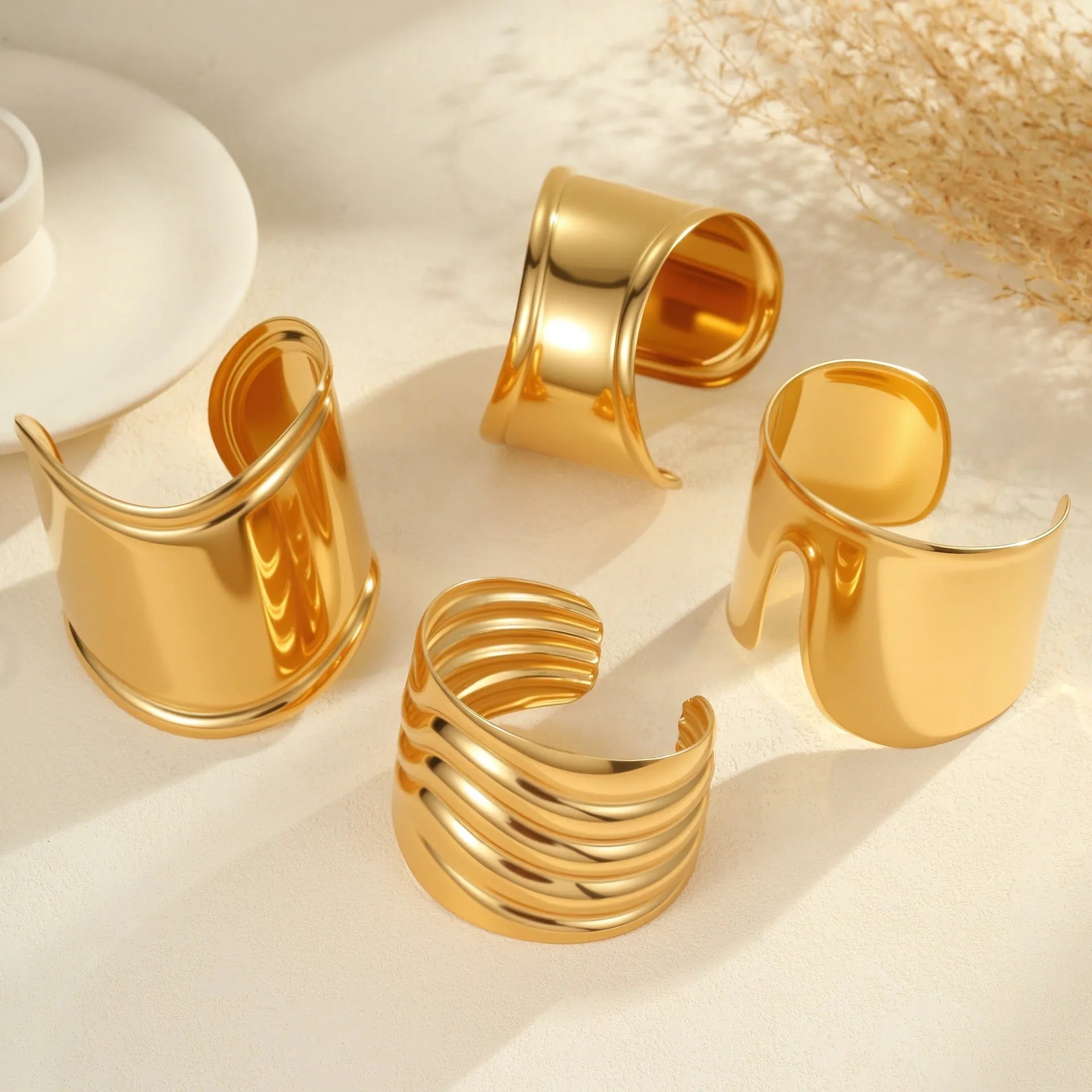 Women's stainless steel bracelet with 18K gold plating featuring wave geometric design