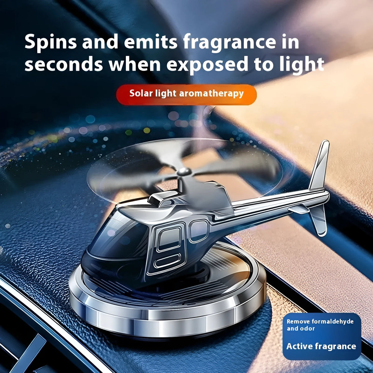 Silver solar-powered metal helicopter car air freshener ornament with rotating blades on a dashboard.