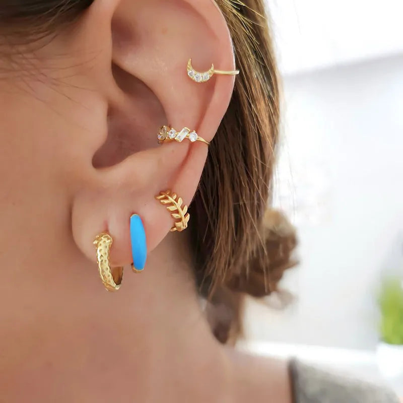 A pair of colourful epoxy oval curved earrings made from silver needle copper wire in a geometric U-shape design.