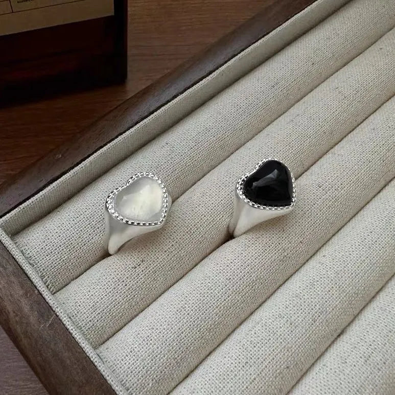 Adjustable opening sterling silver ring with black agate heart stone design on finger