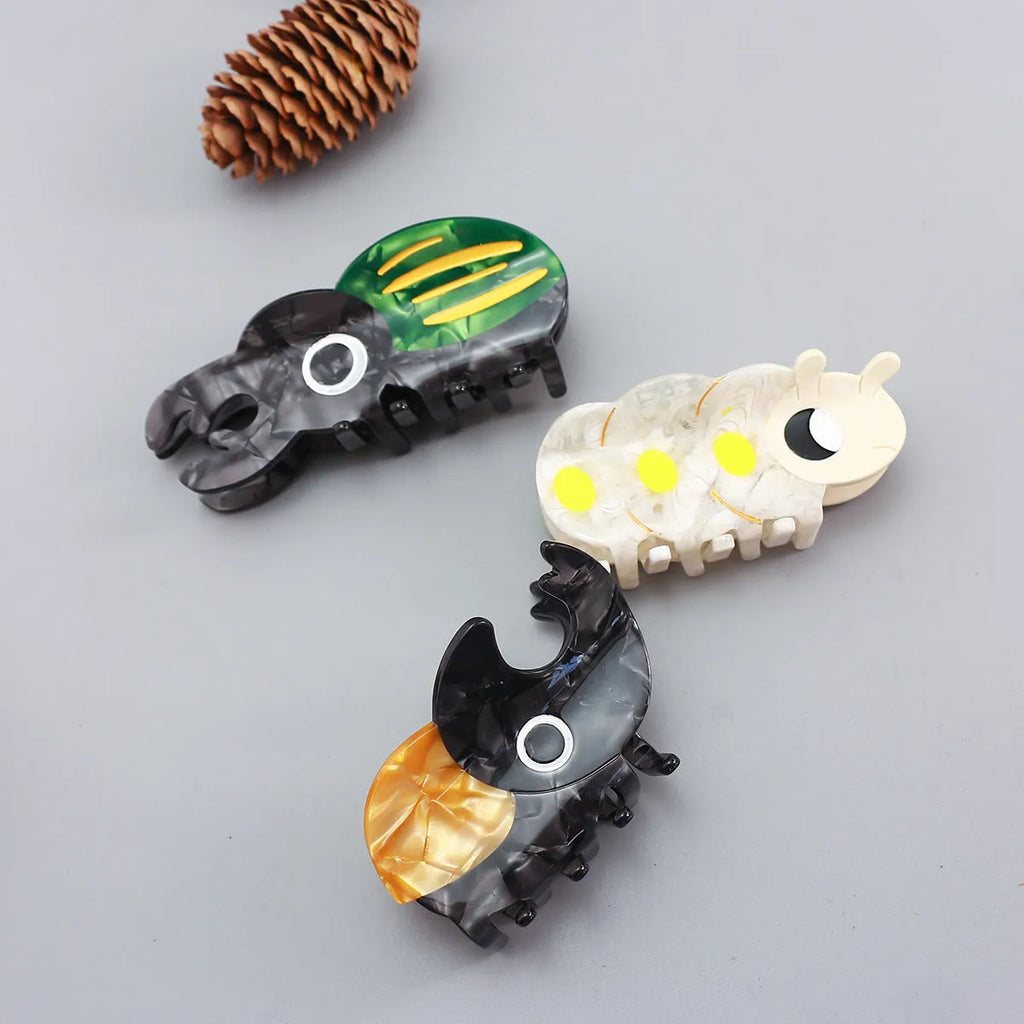 Cellulose acetate insect grip sheet with handmade beetle or caterpillar cartoon design