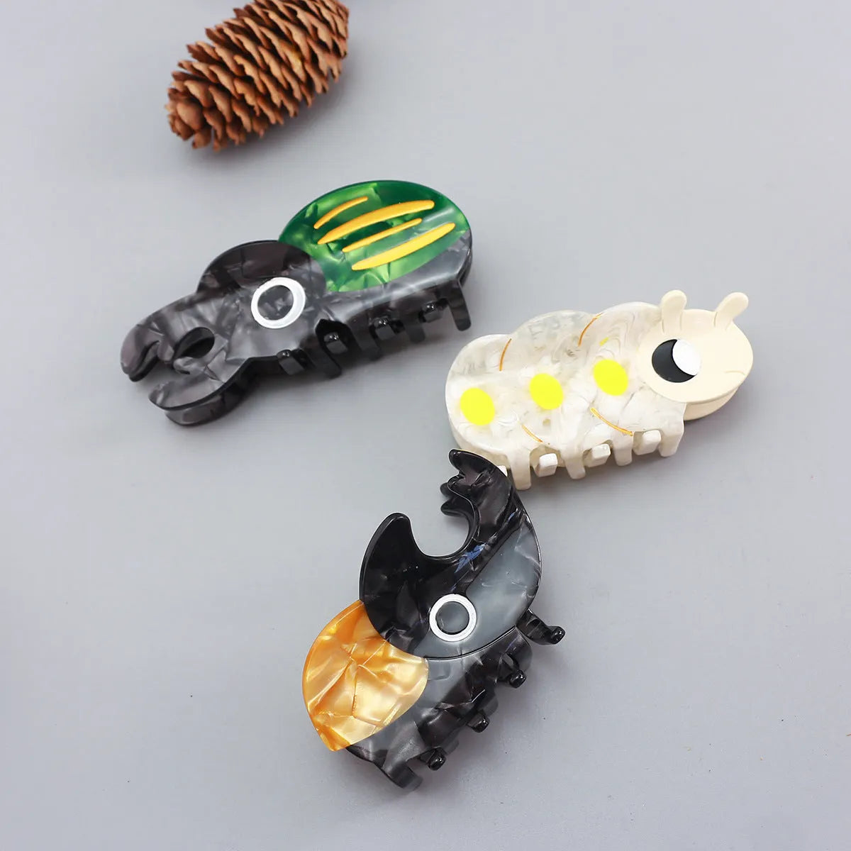 Cellulose acetate insect grip sheet with handmade beetle or caterpillar cartoon design