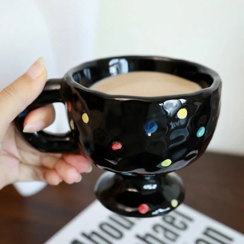 Hand-pinched irregular ceramic mug in a solid colour, shown from the side to display its unique shape.