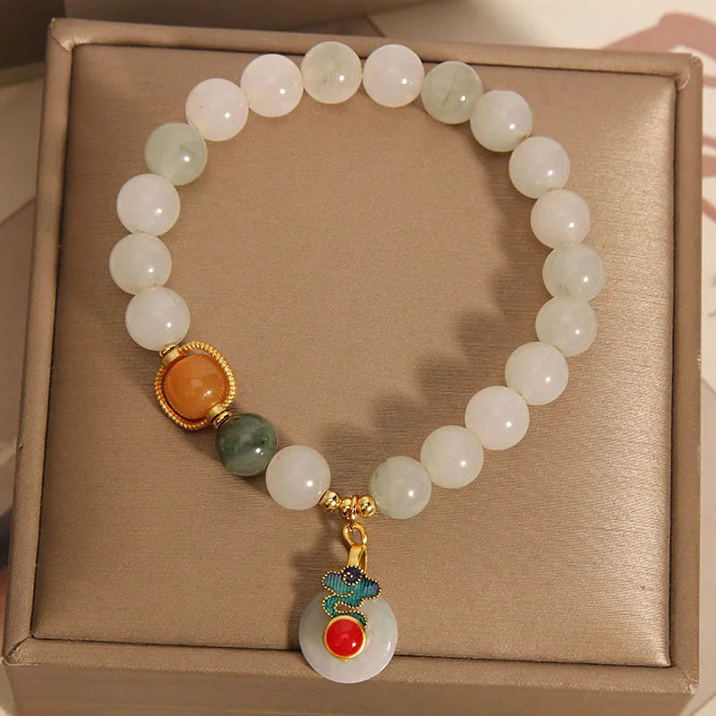 Women's ice jade crystal bracelet with xiangyun peace buckle and pearl accents on a retro-style chain.