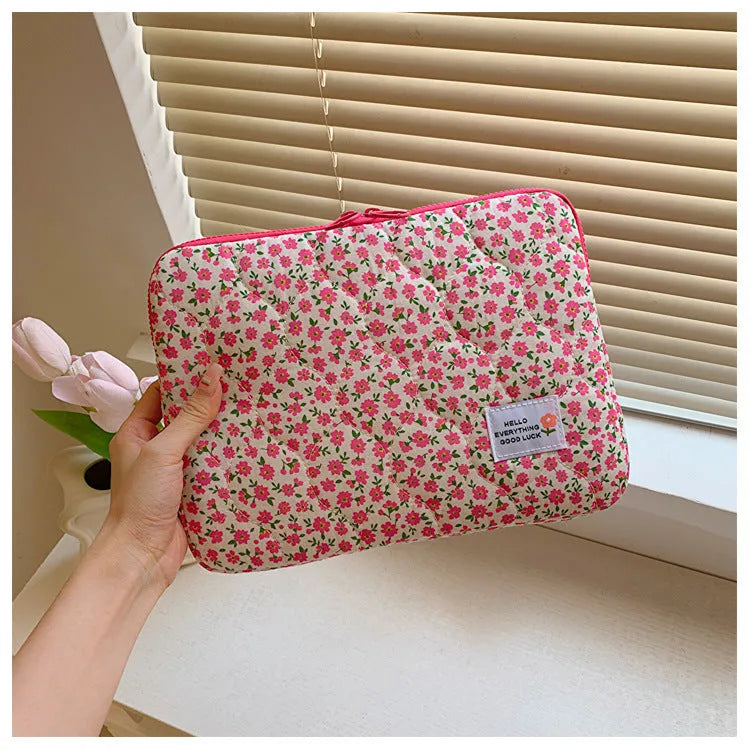 Women's floral print cloth laptop bag showing green flower pattern, available in small, medium, and large sizes.