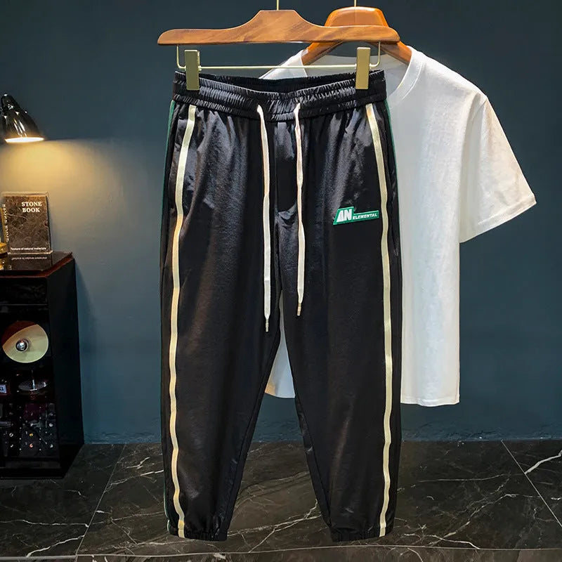 Men's black cotton harem pants showing mid waist and loose fit
