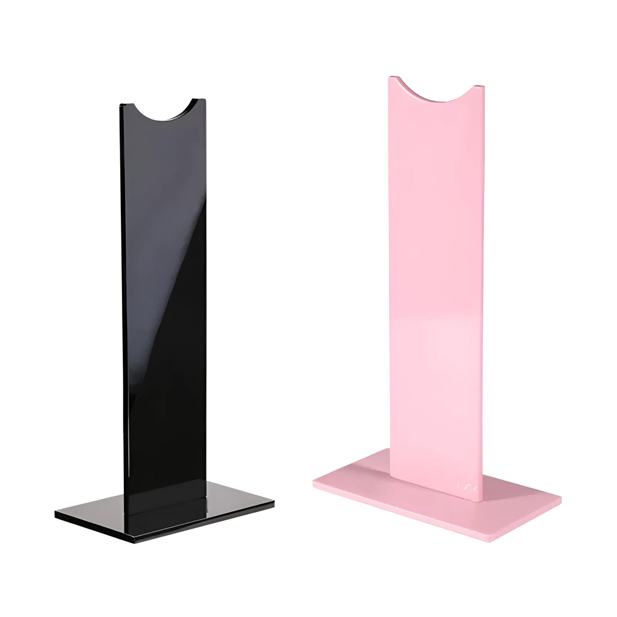 A black or pink detachable headphone stand for head-mounted gaming headsets on a desk.