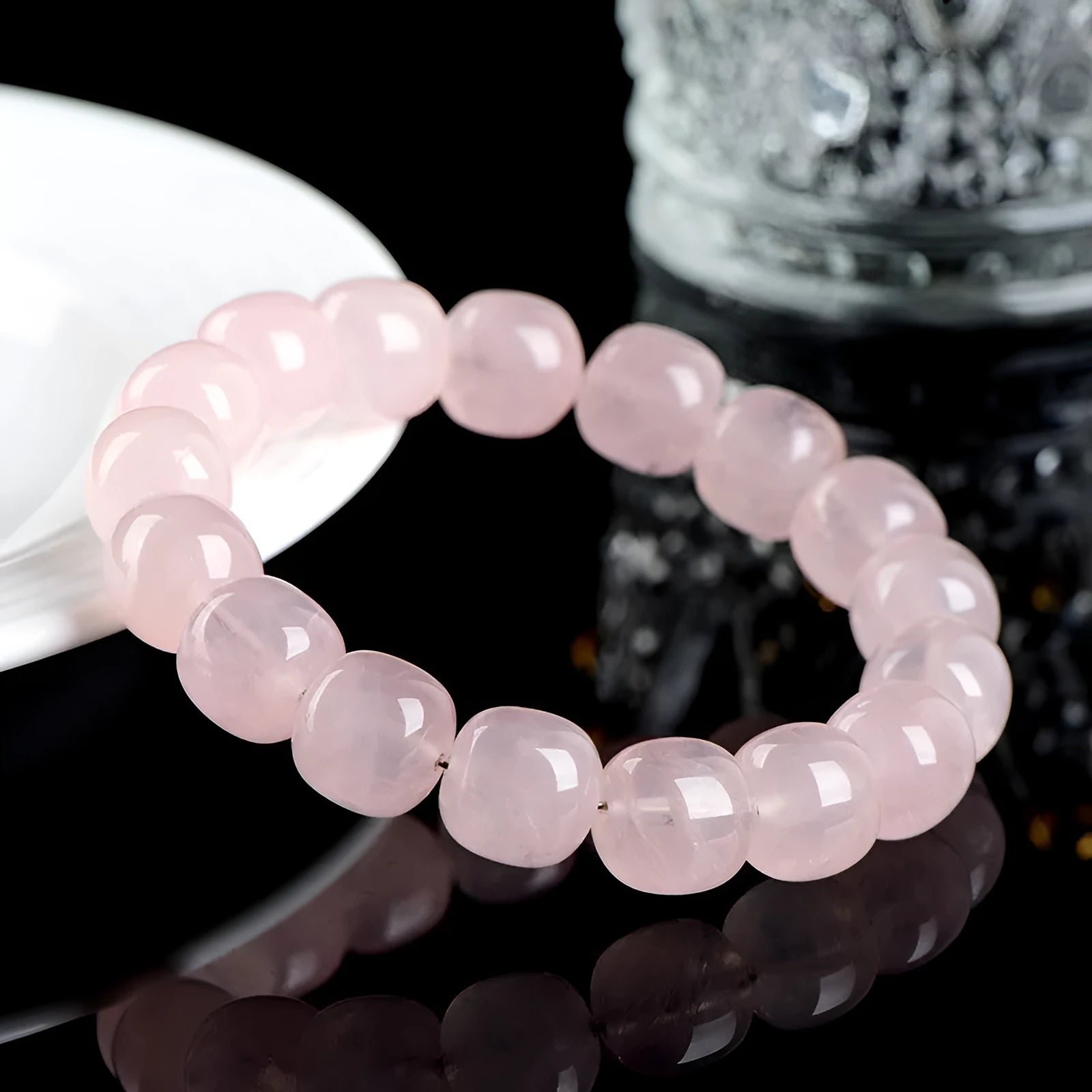 Close-up of a pink crystal barrel bead bracelet with 11-12mm beads on a wrist.