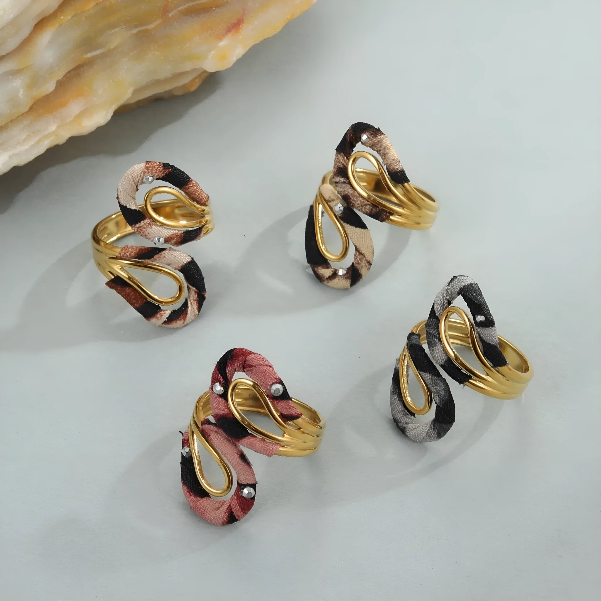 Stainless steel open mouth ring with leopard print and geometric heart or star shape design.