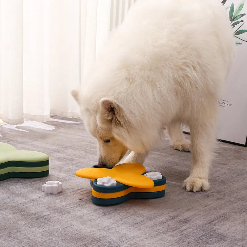 Green and yellow interactive dog puzzle toy with rotatable compartments and bone-shaped covers