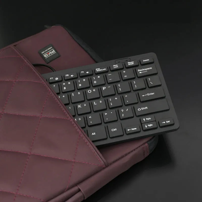 Compact wired USB keyboard in four colour options: black, white, pink, and blue