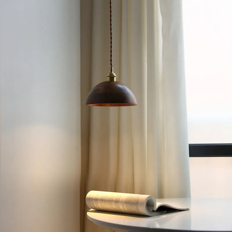 Close-up of a single-head droplight chandelier made from walnut wood art and copper, shown in one of four available colour styles.