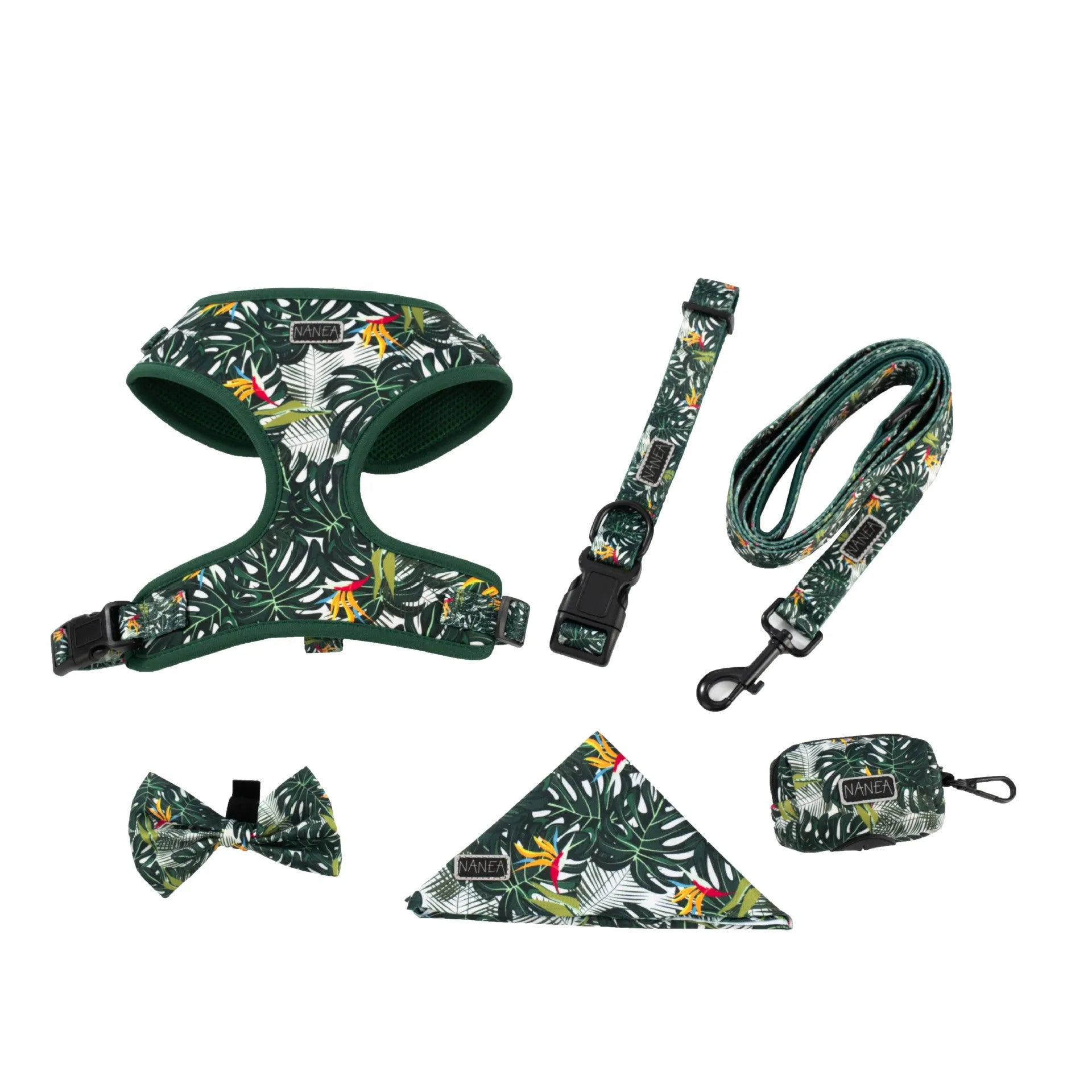 Six-piece adjustable cloth dog harness set on a table, showing vest, collar, rope, waste bag, bow, and triangular scarf.