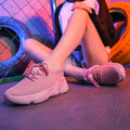Women's white thick-soled sports shoes with woven mesh upper and front adjustable strap.