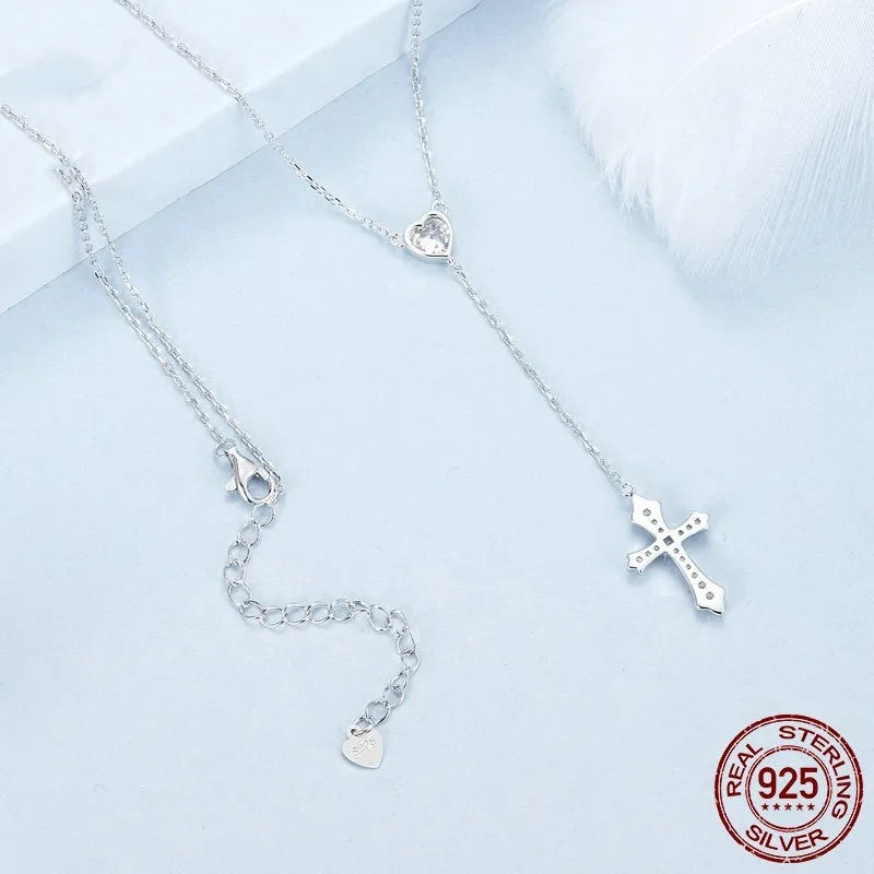 Women's silver cross necklace with V-neck design and O-ring chain.