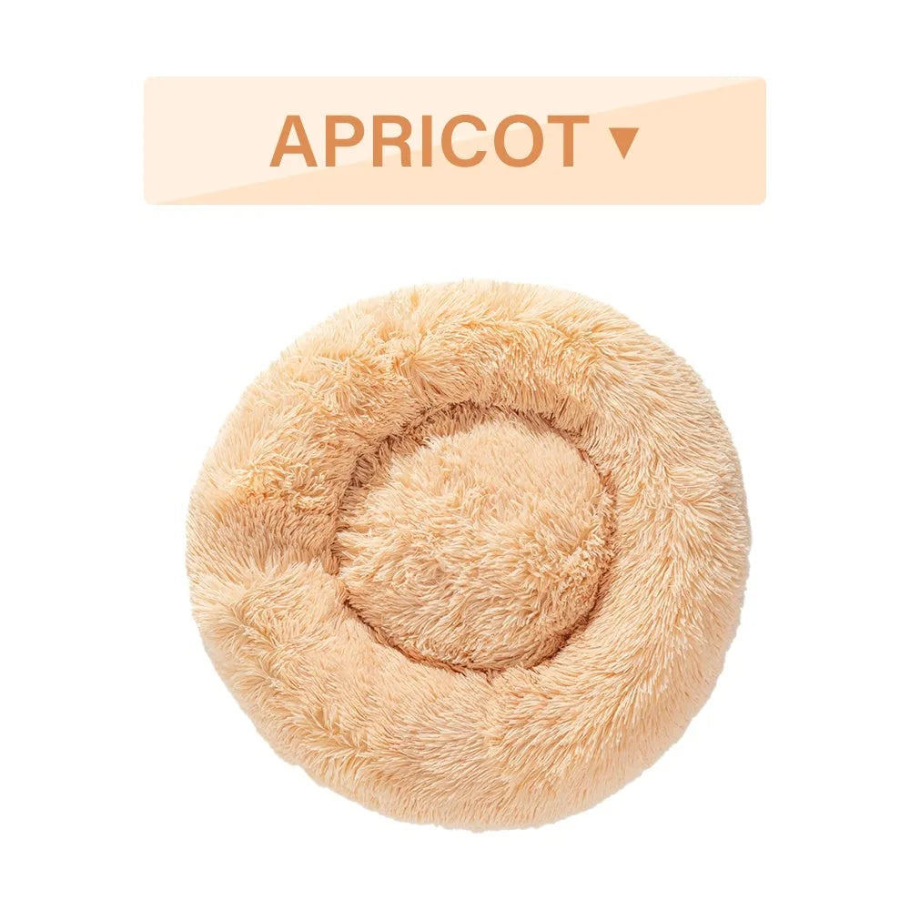 A round donut-shaped dog bed with a raised plush rim, shown in a light grey colour.
