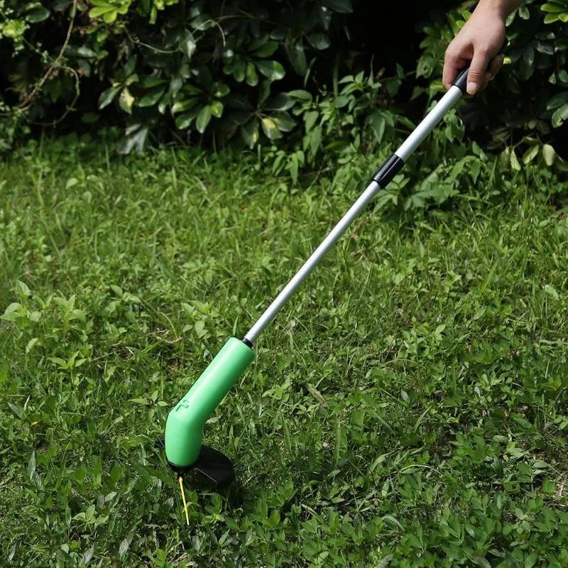 Cordless Zip Trim lawn trimmer with extension pole and protective shield on garden grass