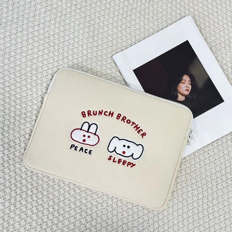 Embroidered laptop sleeve with animal design showing polyester construction and laptop size compatibility