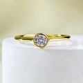 Minimalist silver crown-shaped ring with linear details, shown in gold and platinum finishes.
