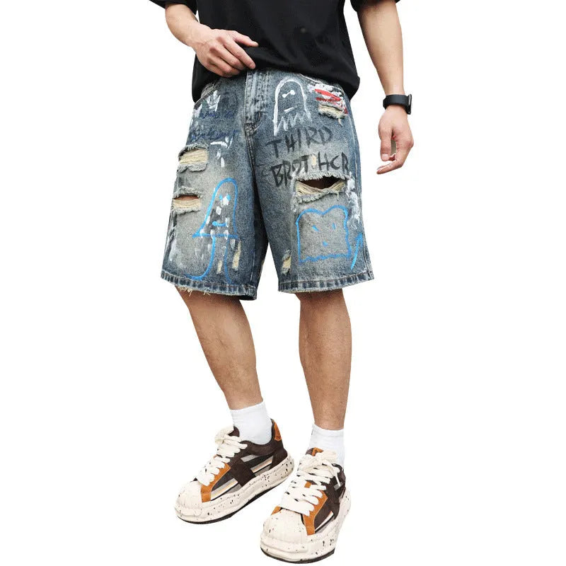 Blue ripped men's denim shorts with graffiti print and straight-leg cut.
