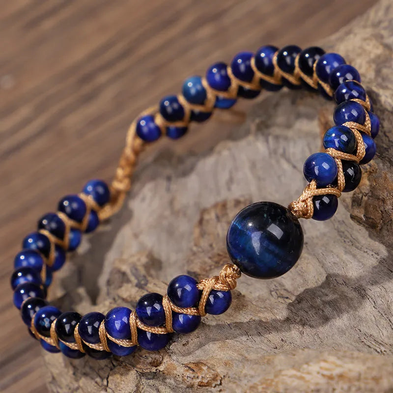 Handwoven geometric pull bracelet made from blue Tigereye stone beads with amethyst details