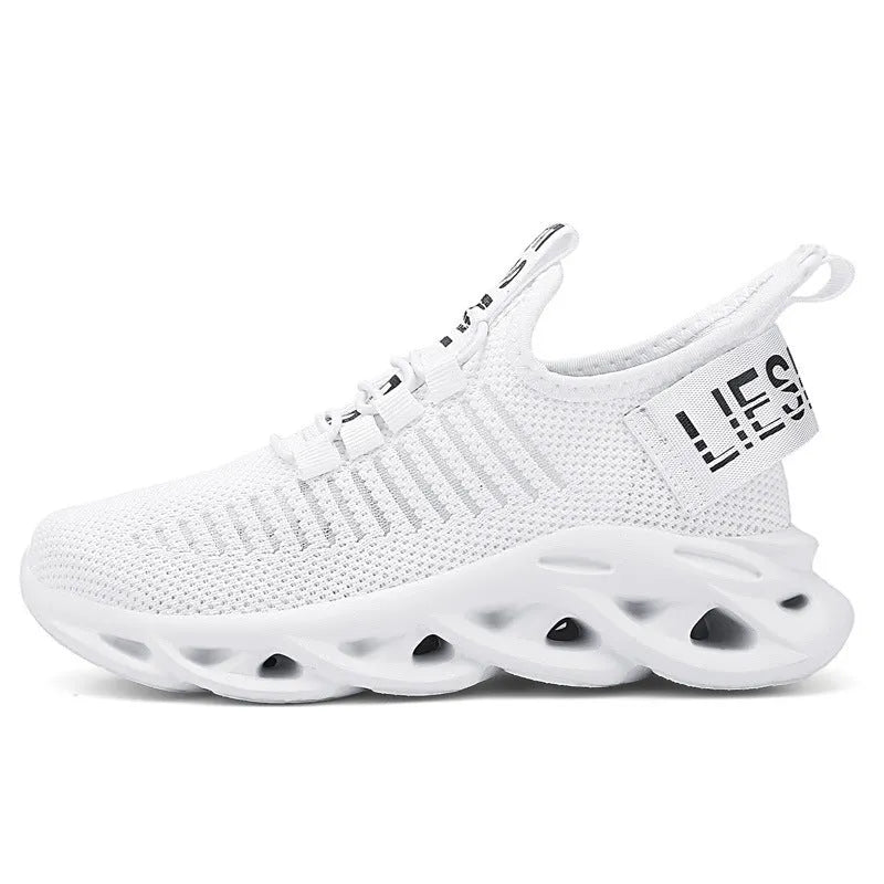 Children's fabric sneakers with Velcro strap in black, khaki, and white colours on a neutral background.