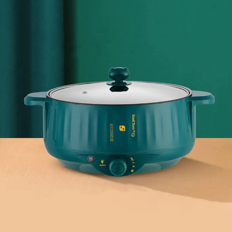 White electric hot pot with non-stick interior and UK plug on kitchen counter