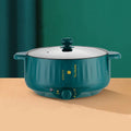 White electric hot pot with non-stick interior and UK plug on kitchen counter