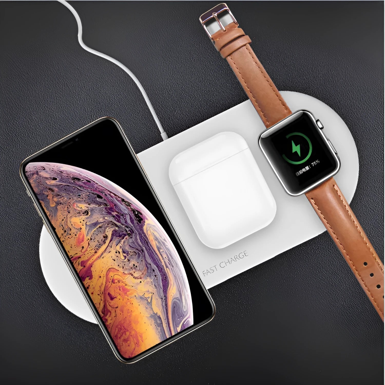 Black and white three-in-one wireless charging station for iPhone, Apple Watch and headphones on a desk.