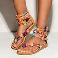 Women's beaded petal floral sandals with ethnic design on a light background.