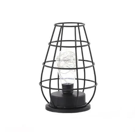 Minimalist wrought iron hollow table lamp in red wine glass style with warm white glow.
