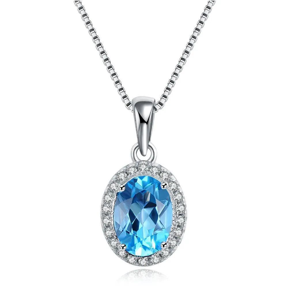 925 sterling silver jewellery set with blue topaz gems in geometric design including earrings, ring, necklace and pendant