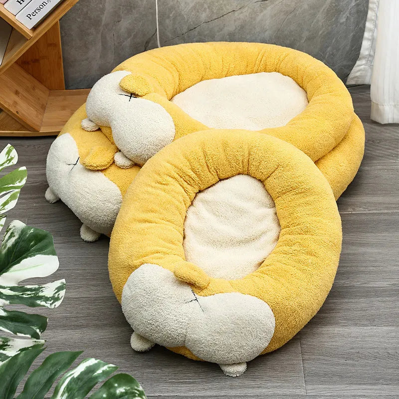 Brown and white corgi-shaped plush pet bed for dogs or cats on a wooden floor.