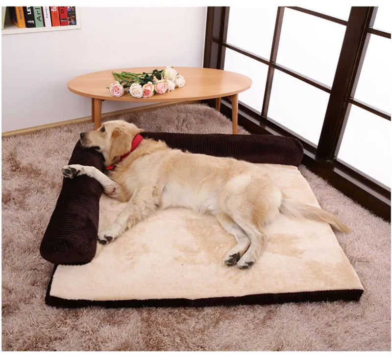 Corduroy dog sofa bed with bolster sides in a grey colour, shown on a wooden floor.