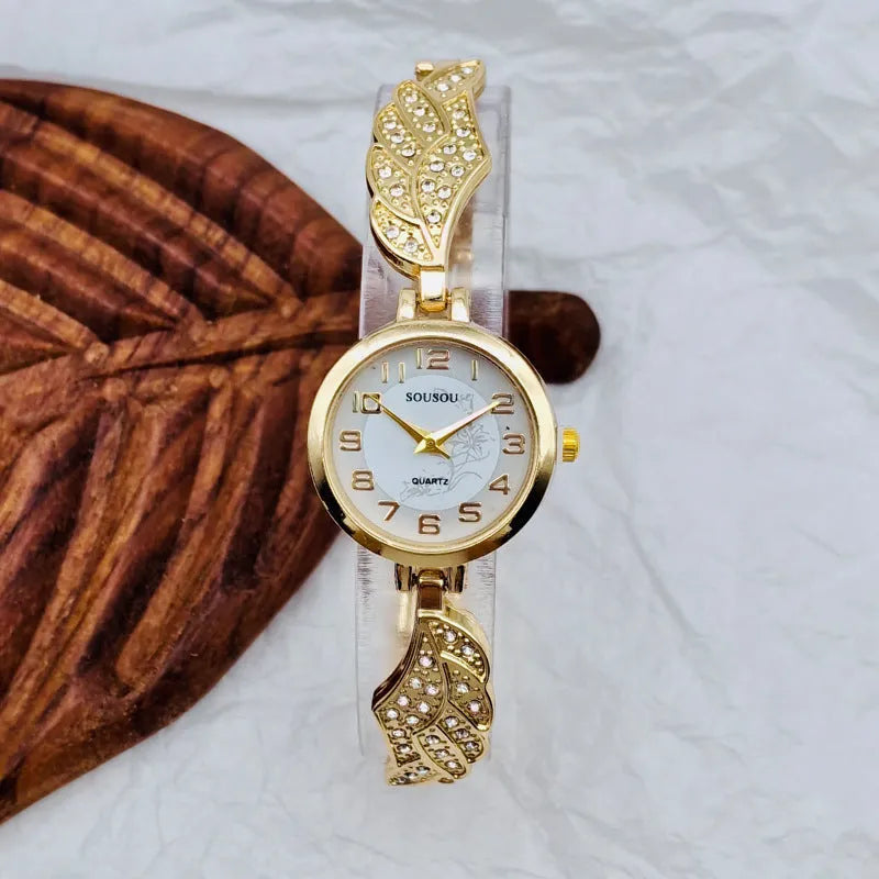 Women's stainless steel watch with round dial and vachette clasp, shown in gold colour.