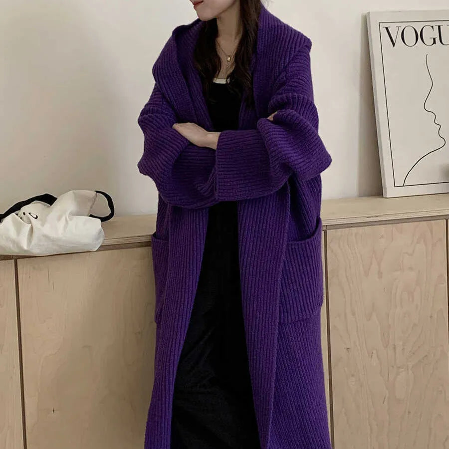 Women's loose grey hooded cardigan coat with raglan sleeves on hanger