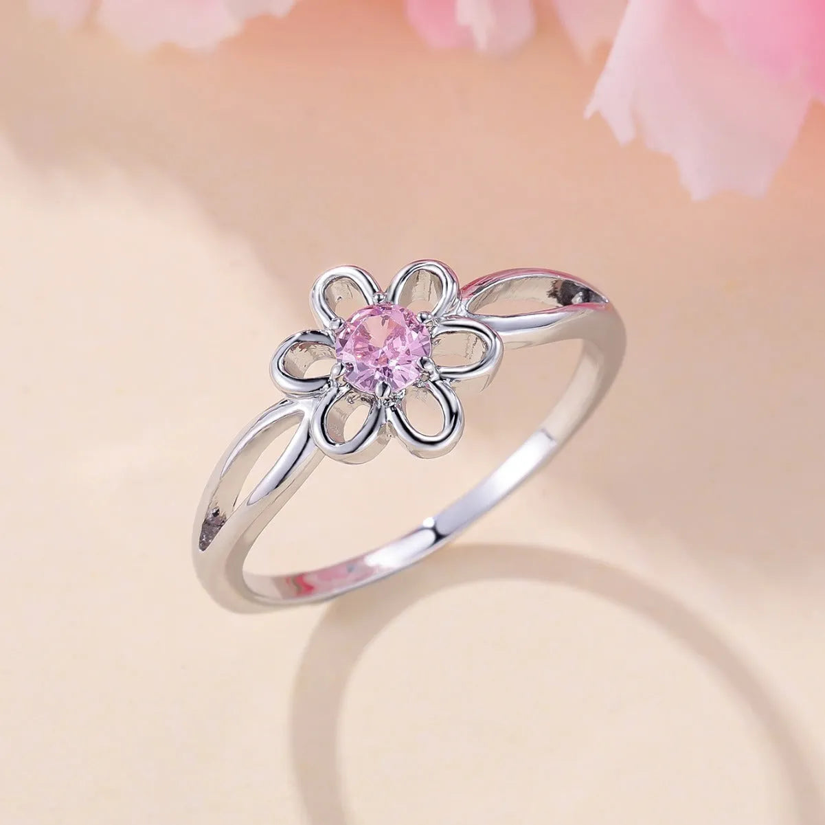 Women's fashion ring with hollowed flower pattern in electroplated copper, platinum pink diamond colour