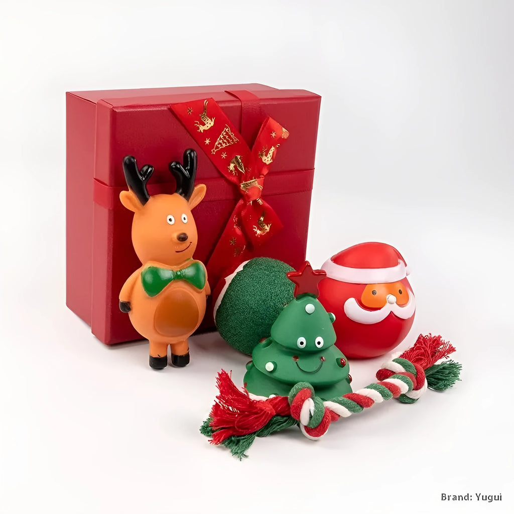 Christmas-themed vinyl dog toys including bite ropes, tennis balls, Santa heads, and deer figures in gift packaging