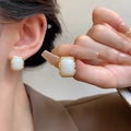 Geometric circular metal earrings with hand-woven texture in X0439 colour
