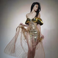 Gold strapless sequined dress with long split skirt on a mannequin
