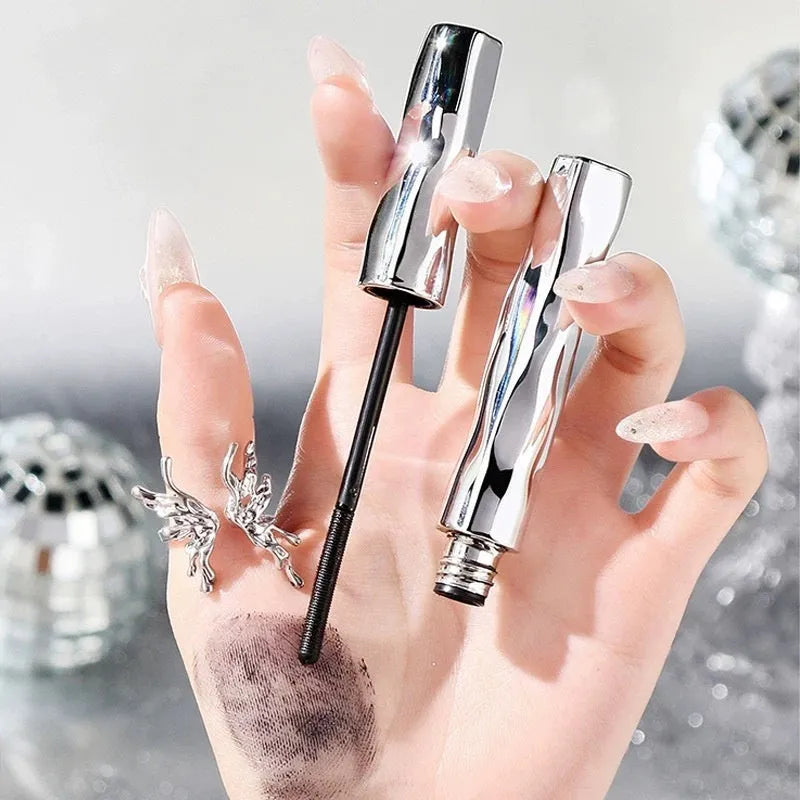 Black and brown waterproof mascara in a steel tube, shown with an optional eyelash curler.