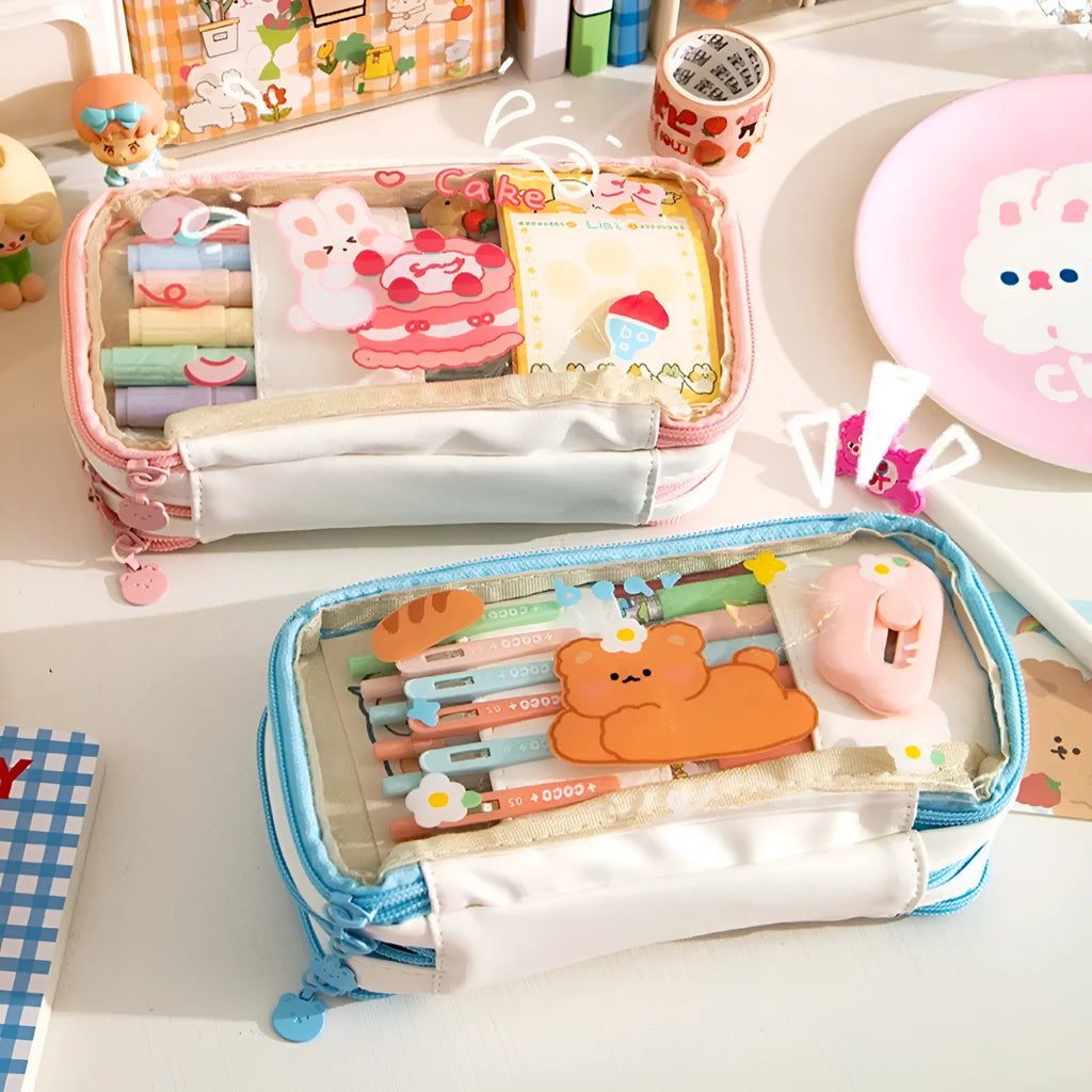 Transparent pen case with Japanese girl and heart graphic in pink or red colour options.