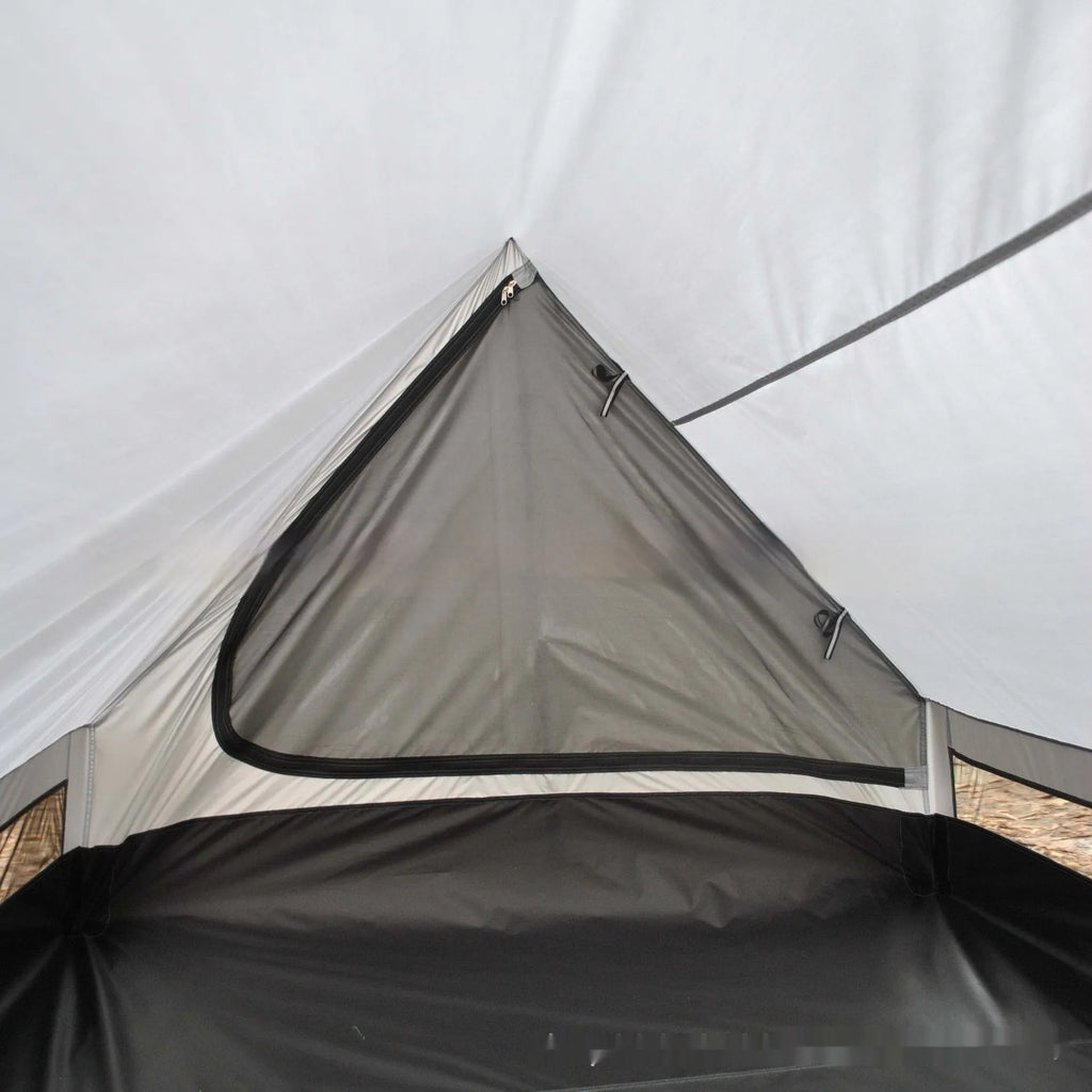 Brown and white pole-free A-line cabin tent set up with hiking canes, showing spacious interior
