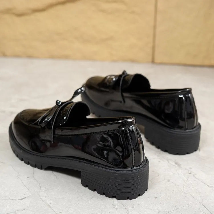 Brown women's pointed-toe loafers with a fabric bow detail on the vamp.
